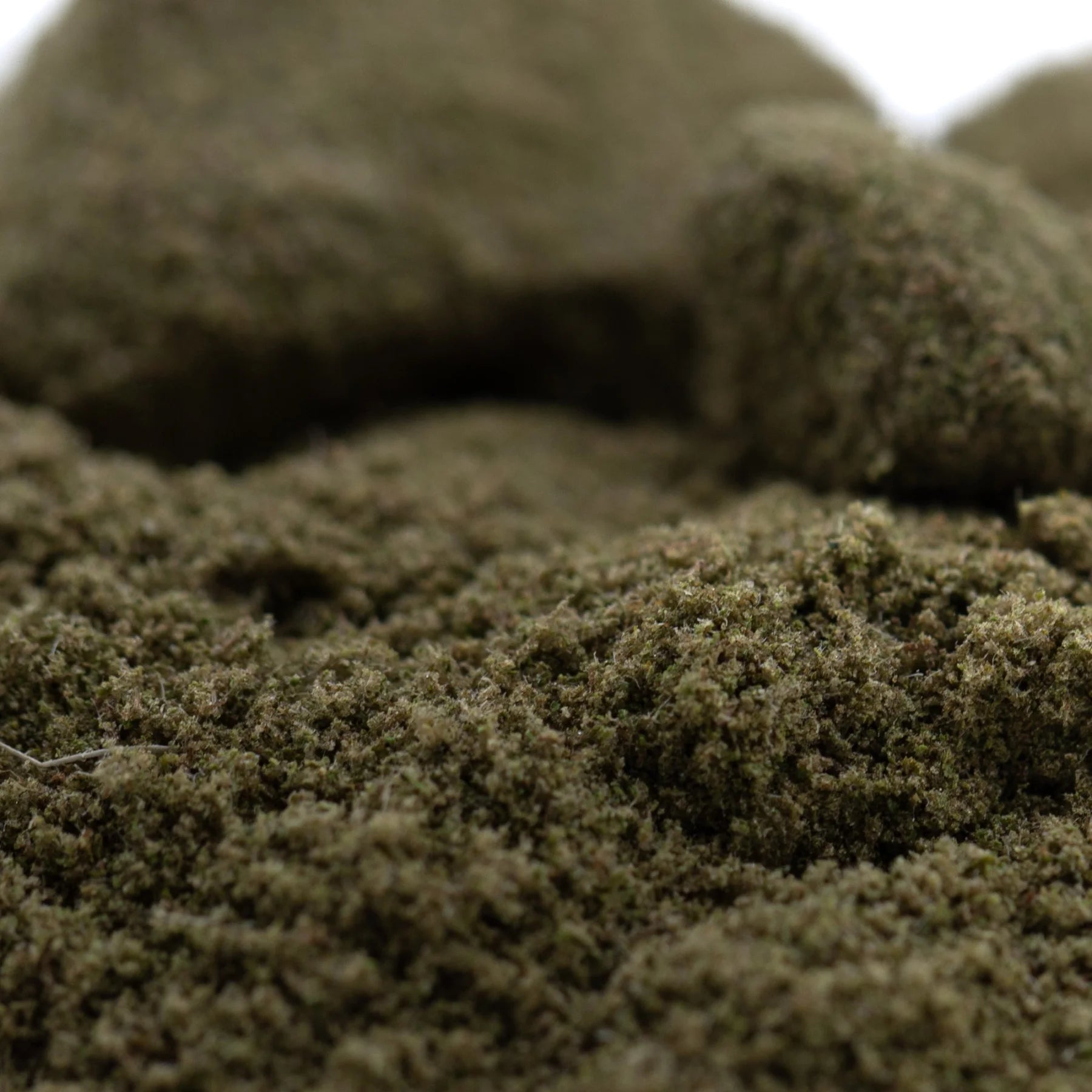 Dense dark green artificial moss with textured fibrous surface for jelly mints thca kief hemp flower product