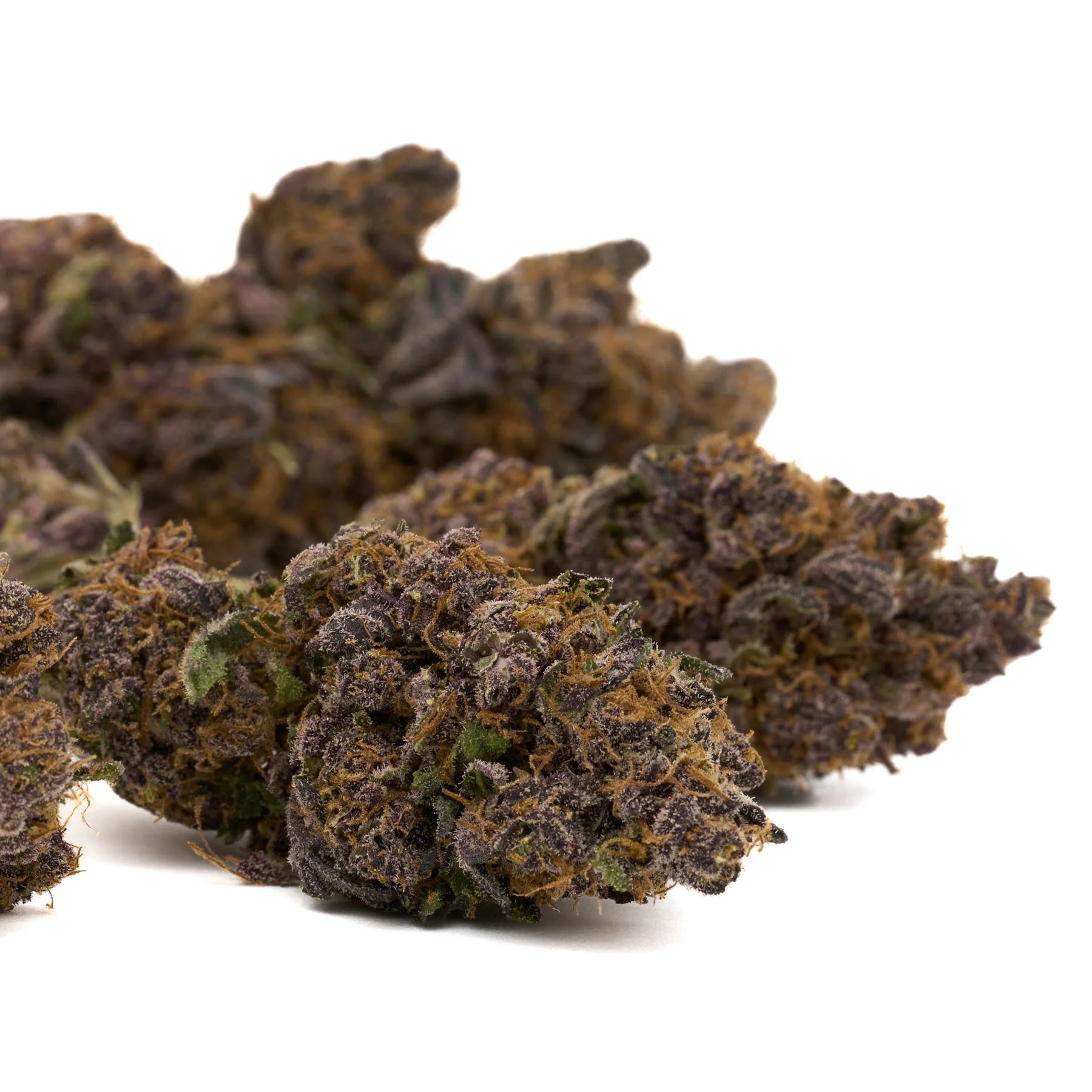 Pile of dark purple and orange cannabis buds from Jimi Hendrix Indoor THCa Flower, sour lemon hemp flower