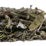A pile of greenish-brown fuzzy jokerz nos greenhouse thca trim leaves ideal for jet fuel gelato and white runtz blends