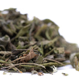 A pile of dried greenish gray greenhouse thca trim leaves and stems from jokerz nos for wholesale use