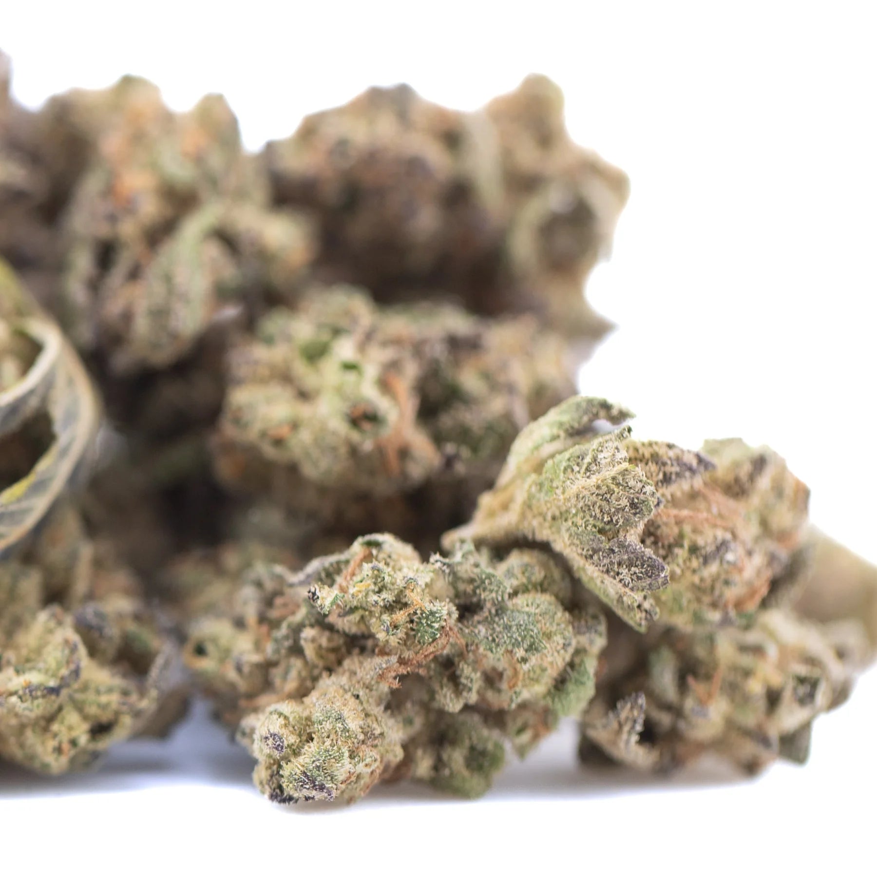 A cluster of dense green and brown lung buster thca hemp flower buds with frosty texture from solfire gardens total cannabinoid