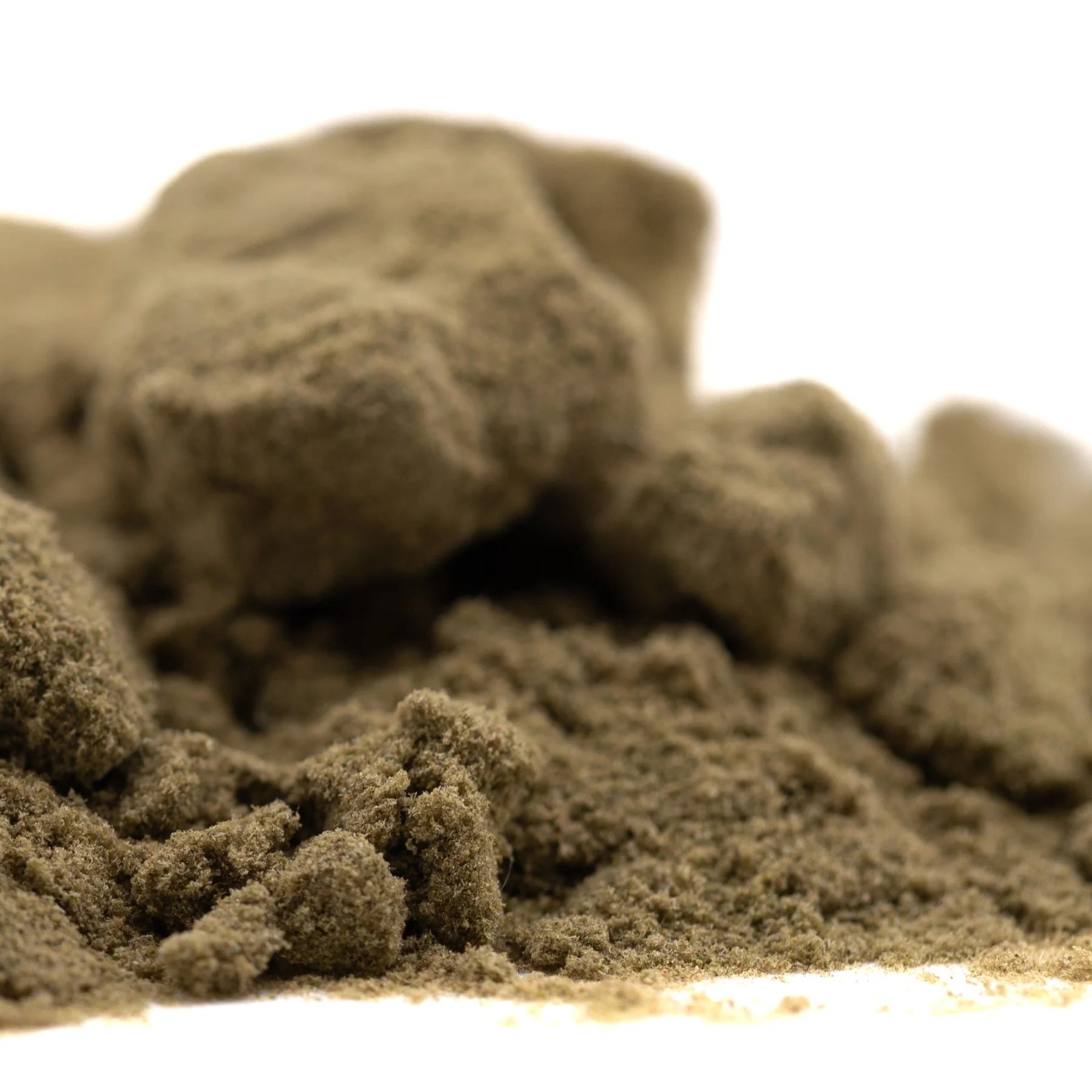 A mound of beige textured kinetic sand showcasing mega gummie bearz enhanced cbd hemp flower kief product
