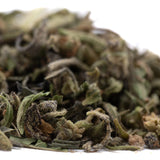 Dried green and brown mendo breath thca trim leaves with fuzzy textured surfaces reminiscent of vanilla caramel candy