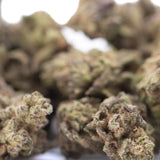 Dense greenish-brown money balls hemp flower with visible trichomes from gary poppins greenhouse smalls