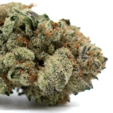 Close-up of Moroccan Peaches indoor THCa flower with trichomes and orange pistils