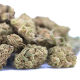 A pile of nascar thca strawnana × papaya greenhouse smalls hemp flower with green and brown hues for physical relaxation