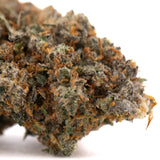 Nectarine Jelly THCa hemp flower bud with green orange hues and trichomes