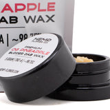 Black cylindrical container with white label holding light amber thca budder wax from pineapple og’s hemp flower 5 gram