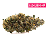 A dense resinous orange runtz indoor thca flower bud with green and orange hues highlighting african orange traits