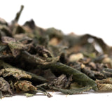 A pile of dried dark green and brown party animals indoor thca trim wholesale tea leaves with curled texture