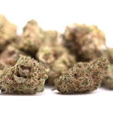 Green and brown frosty hemp flower buds of peach pie thca greenhouse smalls with dessert character hints