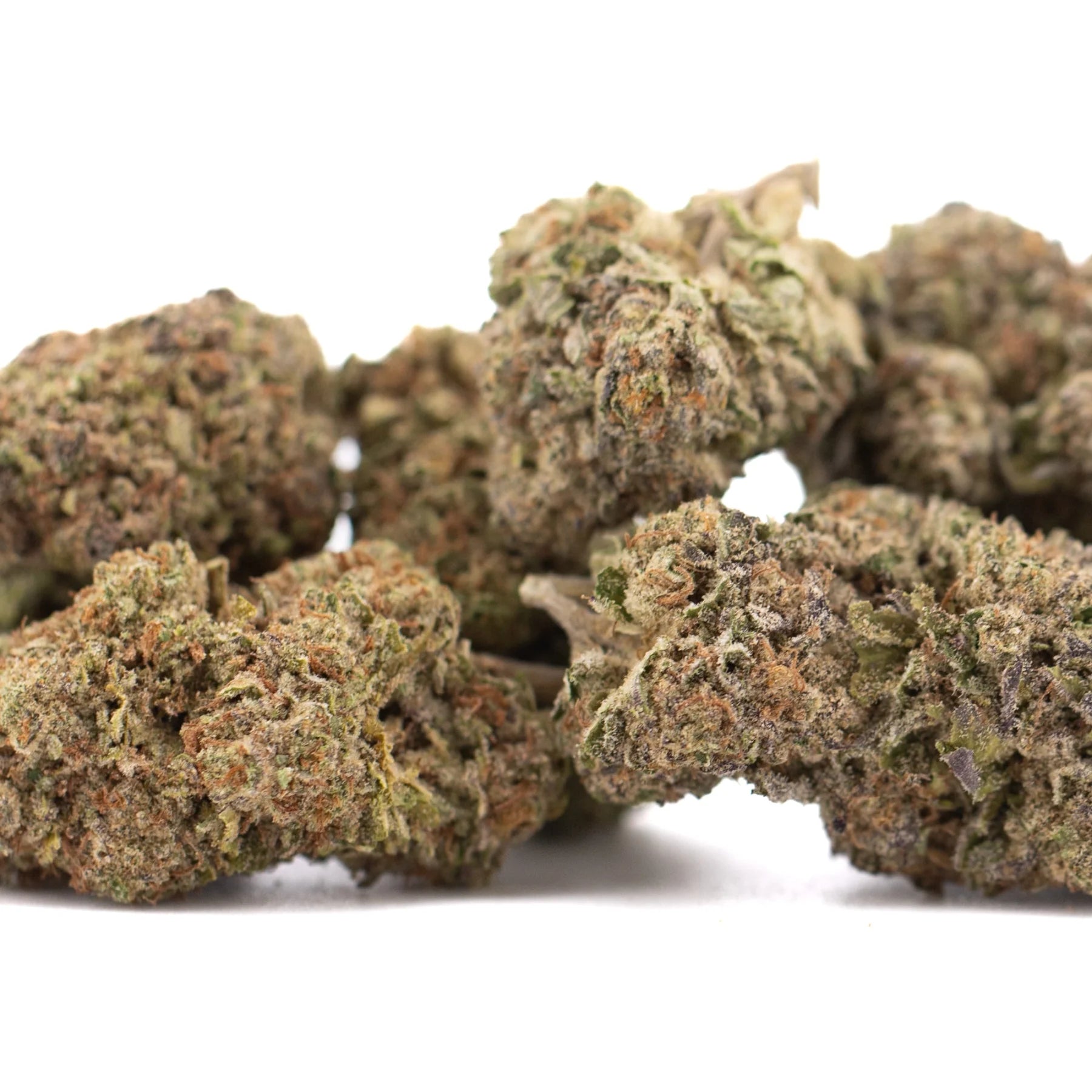 A cluster of dense green and brown peach pie hemp flower buds coated in frosty white trichomes high in total cannabinoids