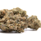 A dense textured peach rainbow indoor thca flower bud with green and brown hues and sour peach aroma