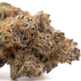 Dense textured sour peach thca flower with green brown and white trichomes from indoor cultivation peach rainbow product