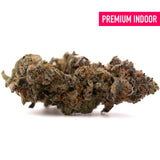 A dense pez indoor thca flower bud with green and brown hues covered in fine trichomes for premium indoor thca