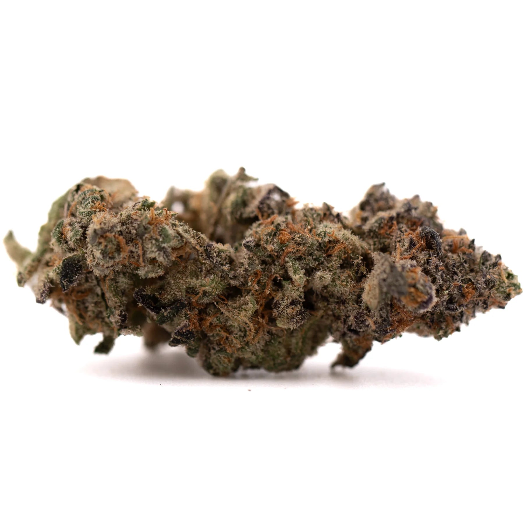 A dense textured pez indoor thca flower bud with green brown hues covered in fine trichomes premium indoor thca