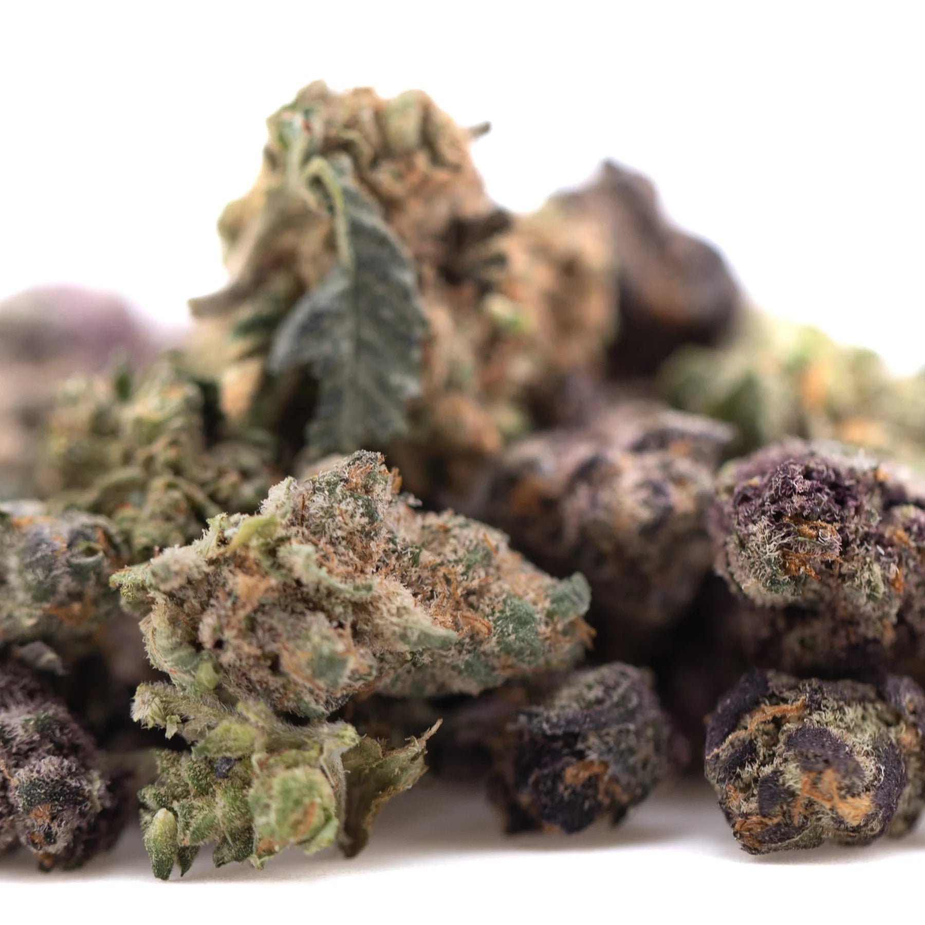 A dense pineapple express thca flower smalls bud with green and purple hues covered in resinous trichomes hemp flower