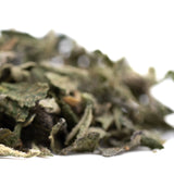Pile of green dried mint leaves from Pineapple Express THCa trim hemp flower