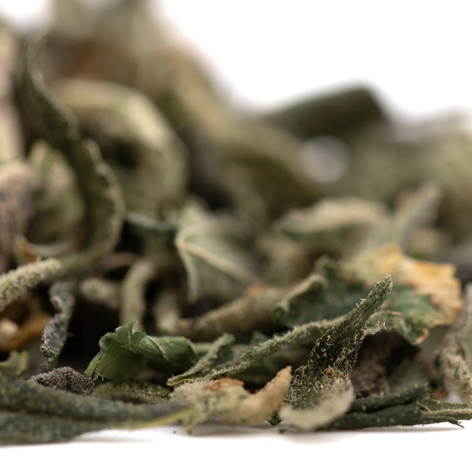 Pineapple Express THCa trim herbal tea blend with greenish-brown dried leaves