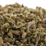 A dense green pivot full-term cbd hemp flower trim with frosty white trichomes and hints of brown showing cbd content