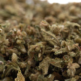 A dense pivot full-term hemp flower trim with green and brown hues covered in fine trichomes and pre-converted cbd content