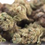 Green and brown poison gushers thca hemp flower buds with a frosty textured surface from greenhouse smalls