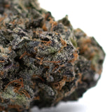 Dried cannabis bud with purple hues and orange hairs from Poppin Bottlez Rozay Cake THCa Flower