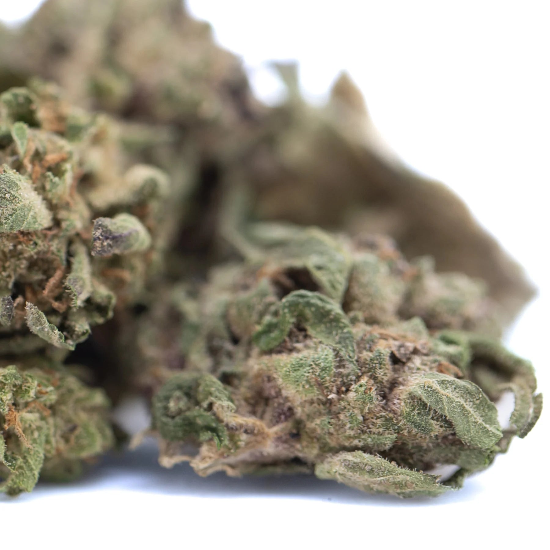A dense green poppin bottlez hemp flower with trichomes and subtle purple hues called rozay cake greenhouse smalls