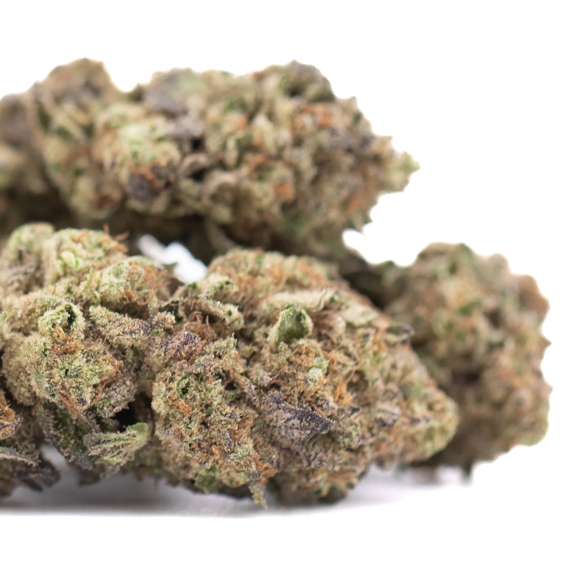 Lush dense rozay cake cannabis buds with green and brown hues covered in trichomes greenhouse cultivation near-maximum potency
