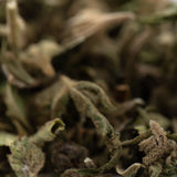 Dried brittle green and brown thca trim wholesale with fuzzy textures showcasing hemp flower cannabinoid content