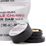 Black cylindrical jar with white label containing purple churro thca budder wax cinnamon horchata 5 gram product
