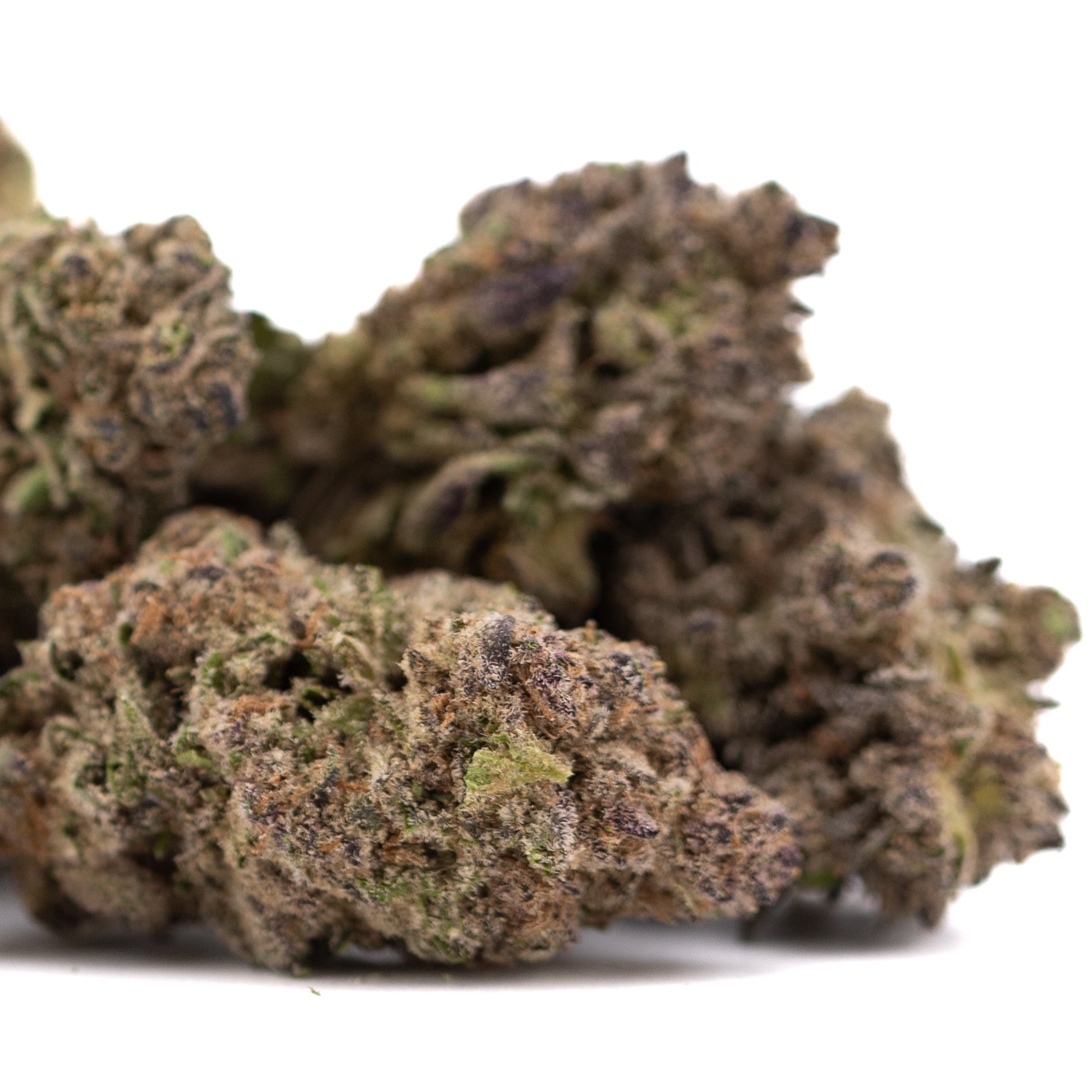 Purple Mountain Majesty THCa hemp flower bud with green hues and trichomes