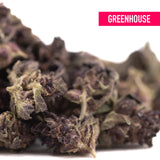 Dense dark purple queen’s thca smalls hemp flower with frosty trichomes and green leaves from hindu kush greenhouse