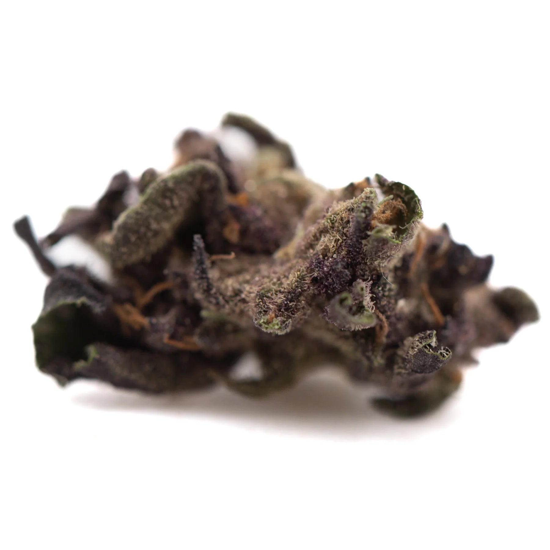 A dense dark purple queen’s thca smalls hemp flower with trichomes and green leaves in greenhouse hindu kush style