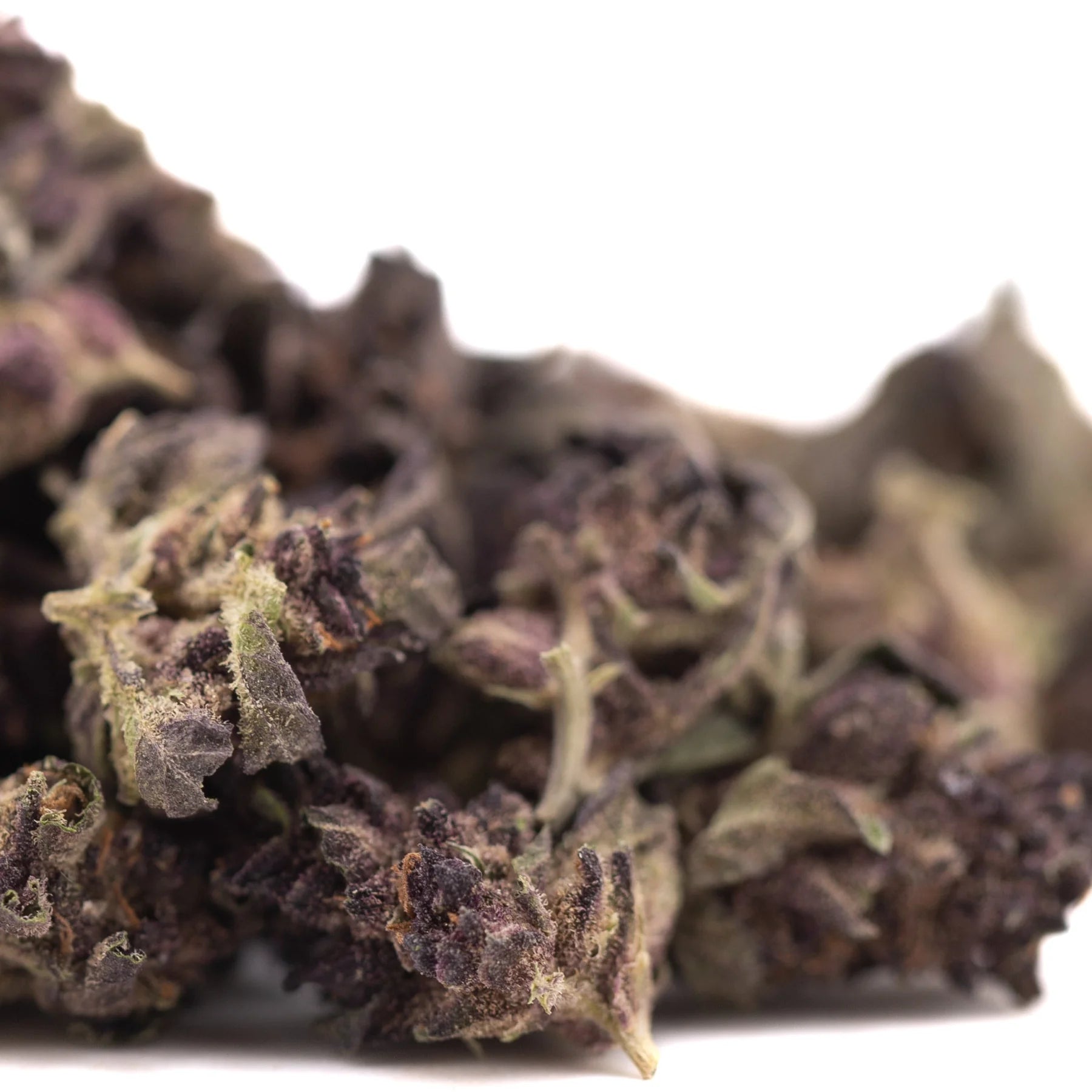 A dense dark purple queen thca flower with fine trichomes and green leaves from hindu kush hemp greenhouse smalls