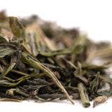 A pile of dried green tea leaves in varying shades for purple wedding wedding cake greenhouse thca hemp flower trim wholesale