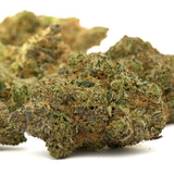 Close-up of Pyromaniac Indoor THCa Flower with dense buds, vibrant green, orange, and purple hues