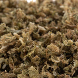 A pile of rna cbd hemp flower trim with green and brown dried buds covered in fine trichomes highlighting the terpene profile