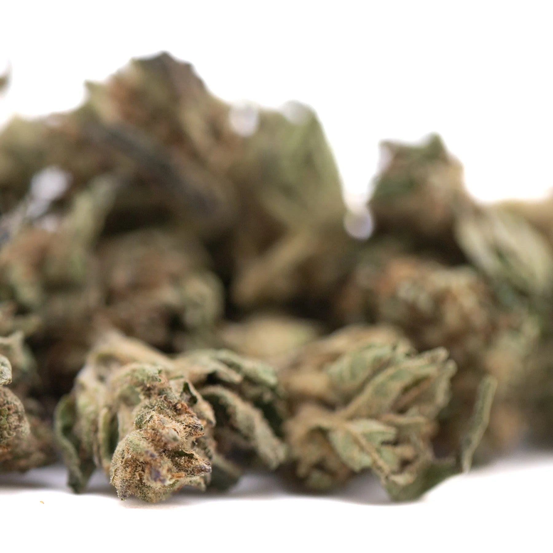 A dense green and brown royal og cbd full-term hemp flower smalls bud with visible trichomes and active cbd terpene profile
