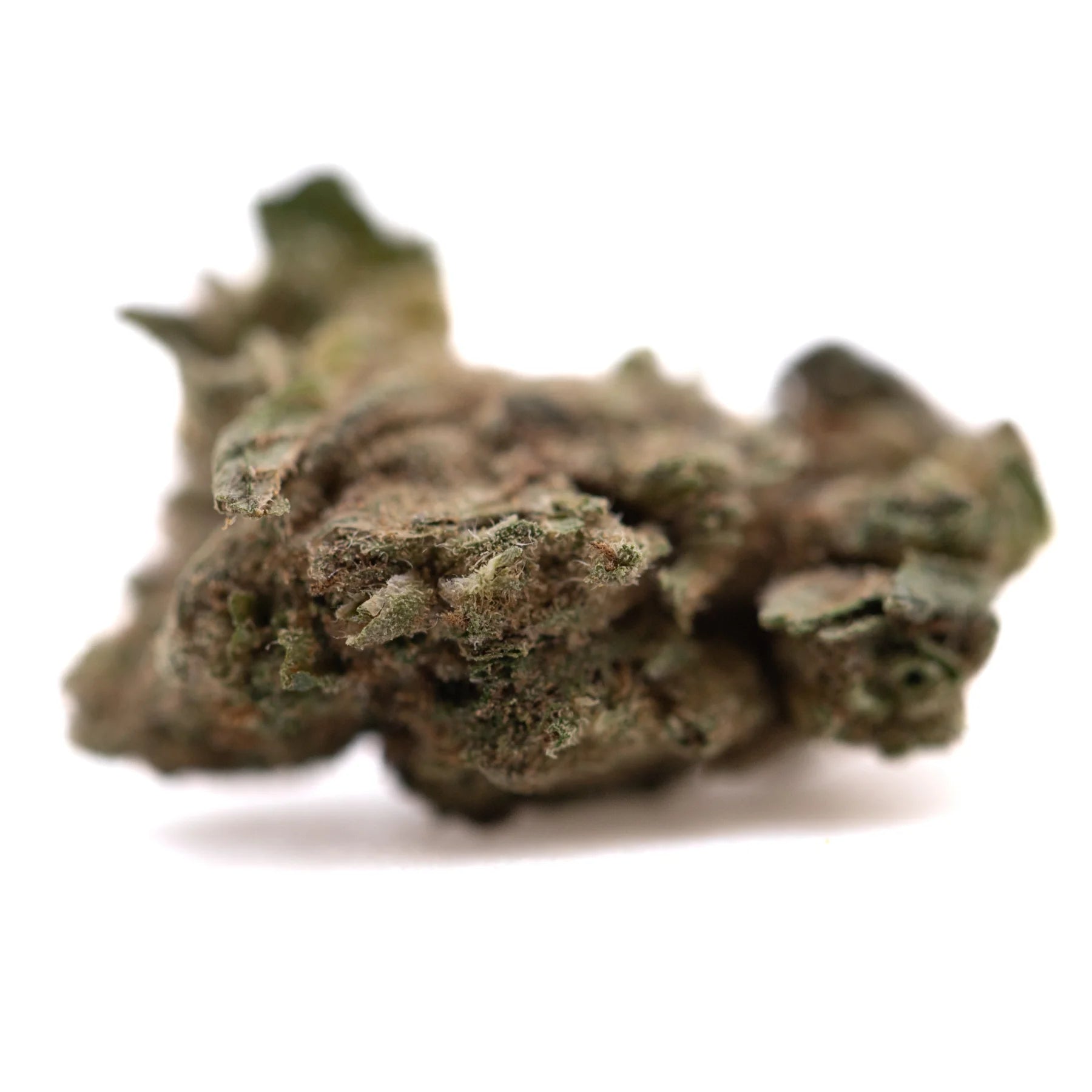 A dense irregular royal og cbd hemp flower small with green brown hues and visible trichomes highlighting active cbd and terpene profile
