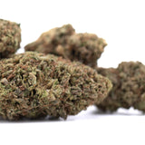 Green and brown royal og cbd full-term hemp flower buds with dense textured surface and high cannabinoid potency for cbd wholesale full-term use