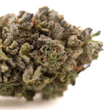 Dense frosty rozay cake hemp flower with green and purple hues covered in thick trichomes wedding cake strain