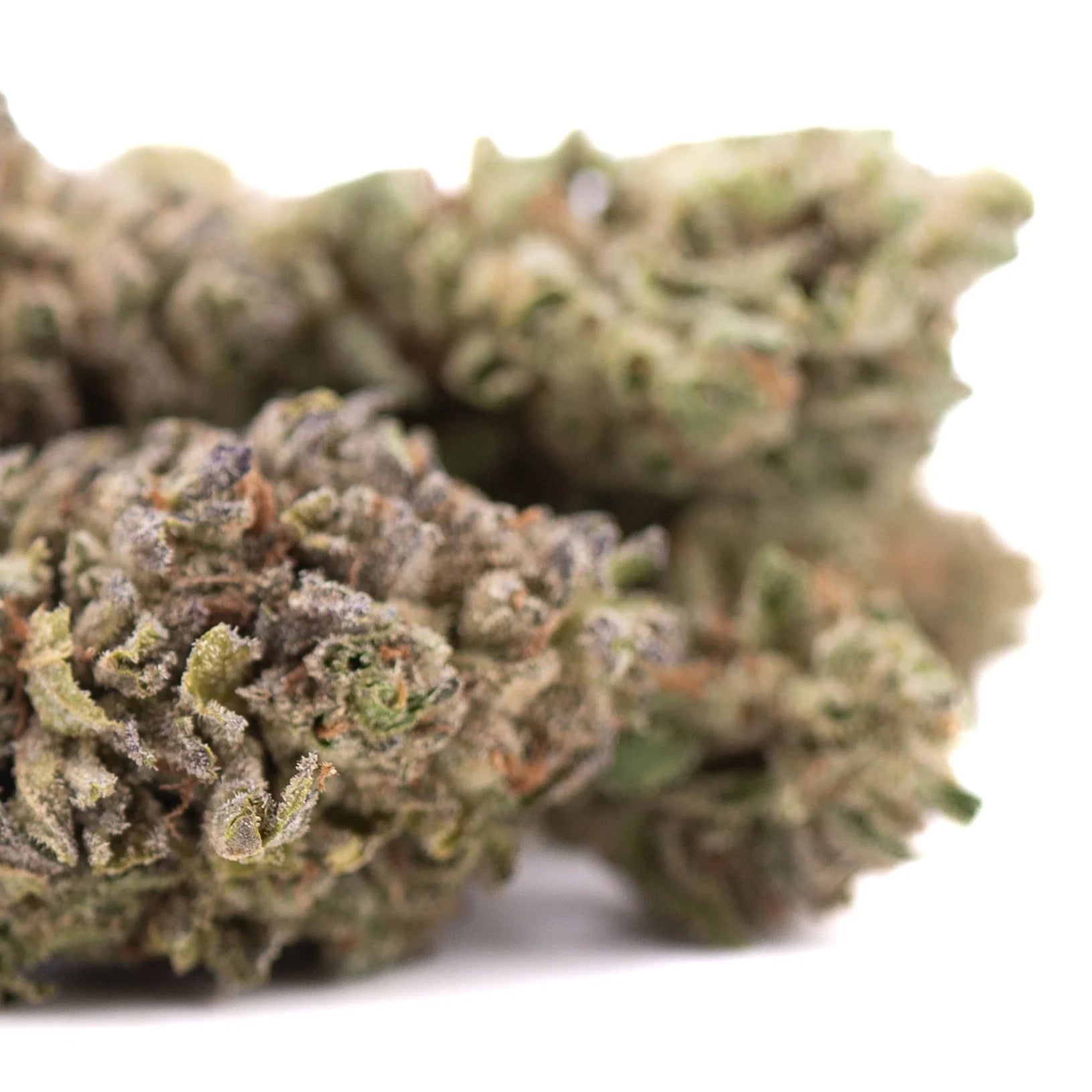 A dense green rozay cake hemp flower with frosty white trichomes and hints of purple and orange pistils wedding cake strain