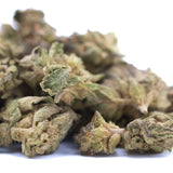 A pile of green rozay cake hemp flower buds with dense trichomes and leaves in greenhouse smalls wholesale packaging