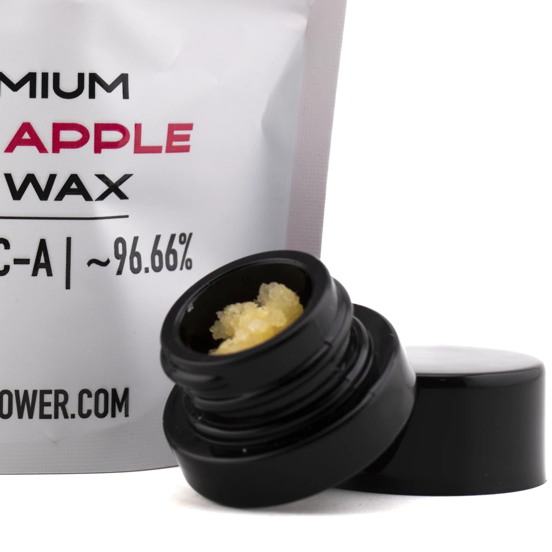 Black cylindrical container with matching lid holding yellowish sour apple 96.66 percent thca dab wax for sativa excellence