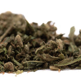 A pile of dried sour apple full-term thca trim with greenish brown buds showcasing legendary genetics and trichomes