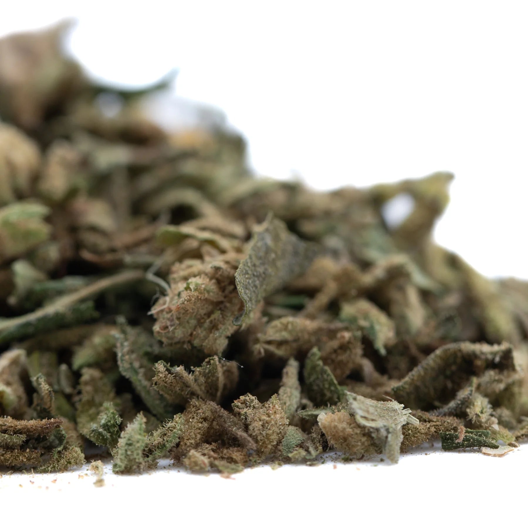 A pile of sour diesel thca trim wholesale hemp flower in green and brown hues covered with fine trichomes