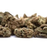 Sour Diesel THCa Smalls: Dense green-brown buds with resin glands