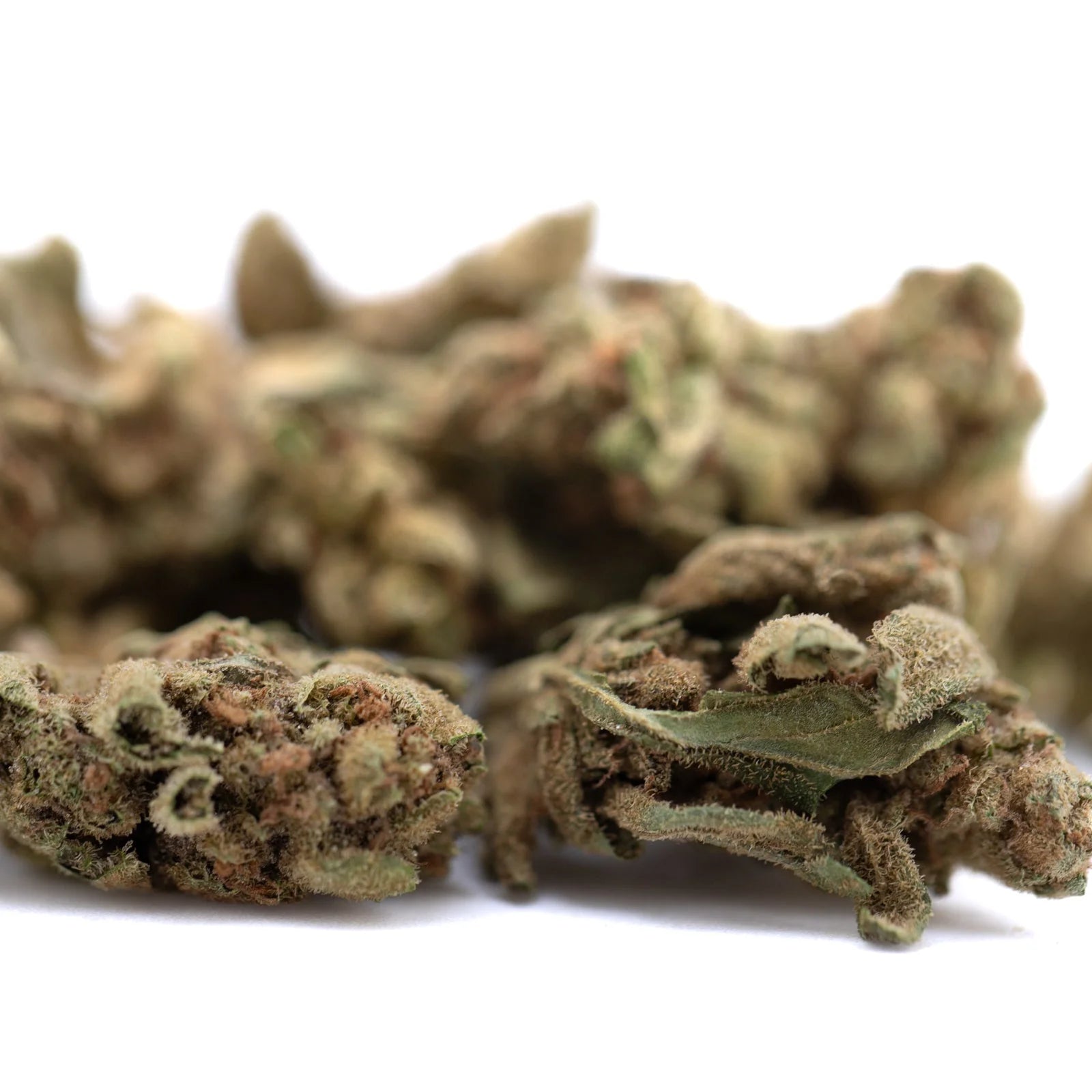 Sour Diesel THCa flower smalls with green leaves and white trichomes
