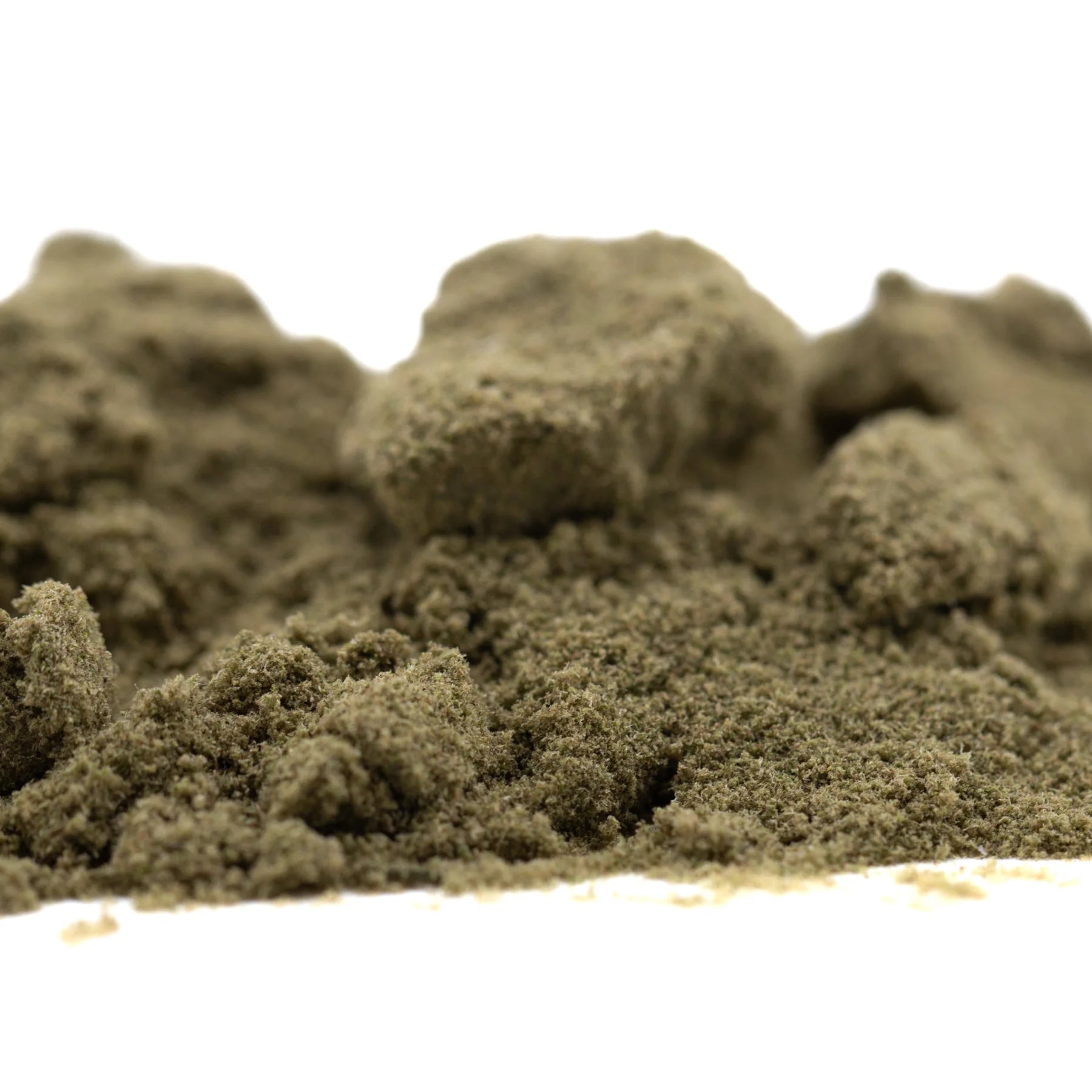 A mound of olive-green sour diesel thca kief with granular texture showcasing industry-leading cbga mexican sativa fuel